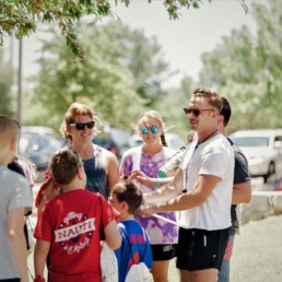 Young adults volunteering to help young children on a day out